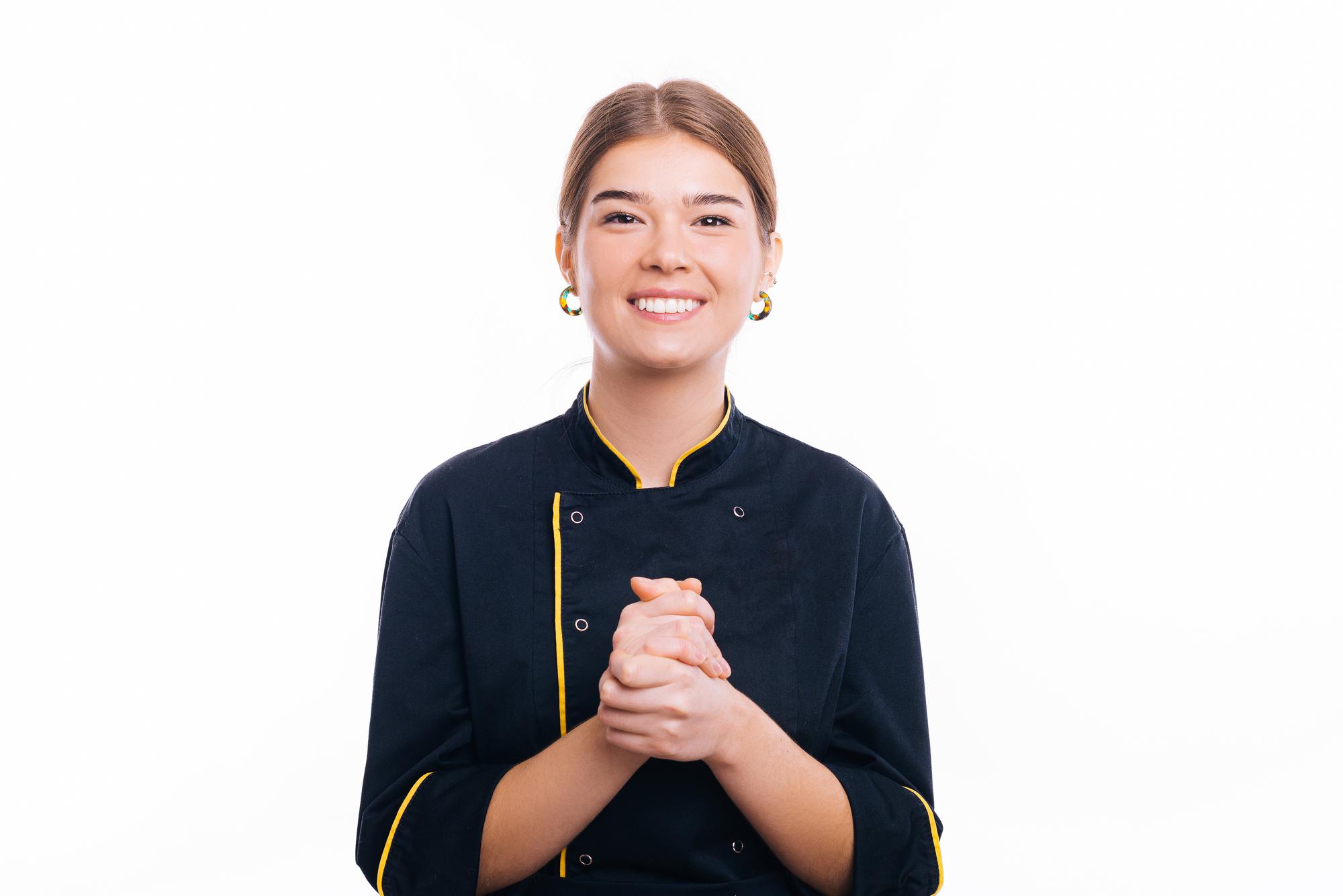 Instructor smiling in a modest kitchen studio